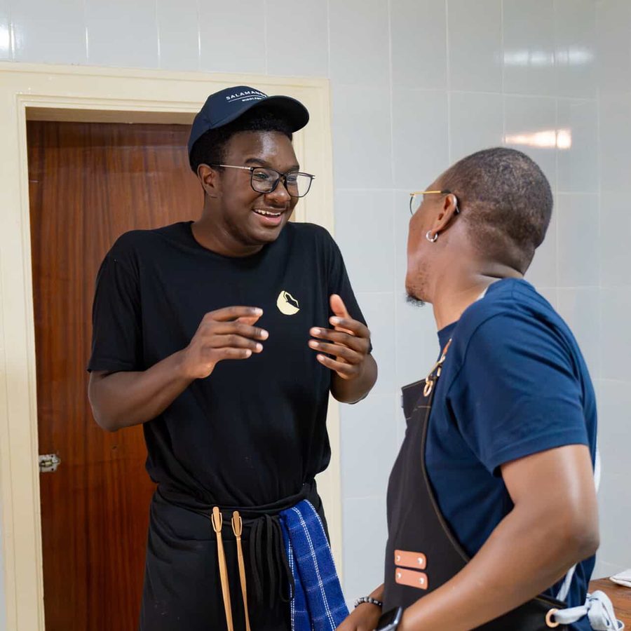 Ace laughing with a chef in the Five Senses kitchen